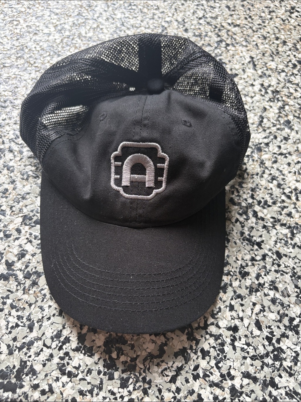 Black Mesh Trucker Hat with White Embroidered Logo